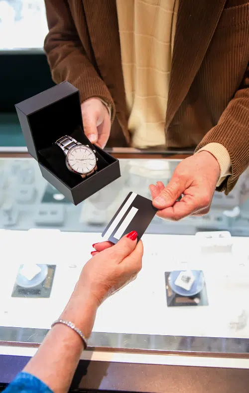 jewelry store owner accepting card payment for a watch