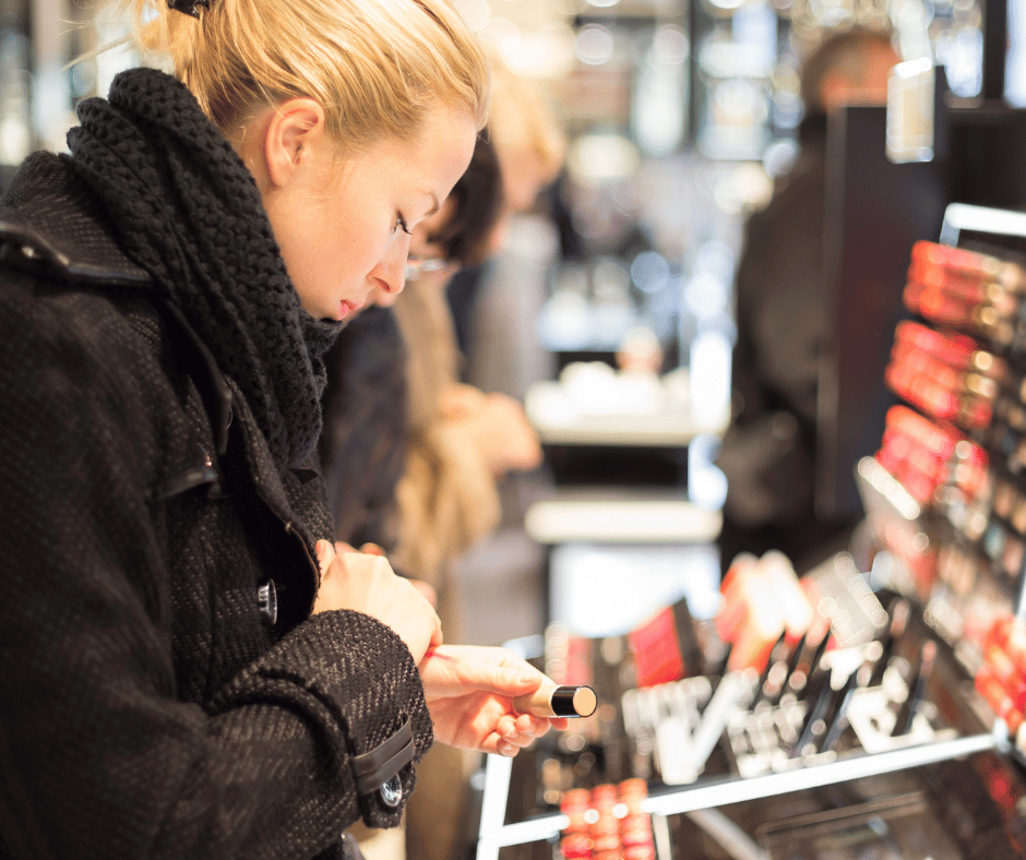a woman looking at cosmetic products in a beauty supply store