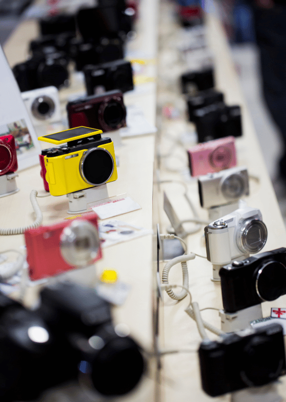 cameras on display inside of an electronics store