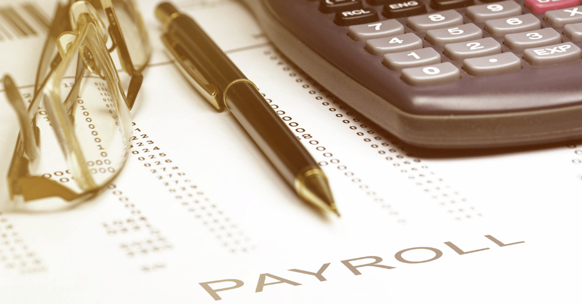 a payroll sheet with glasses, pen, and calculator sitting on top.