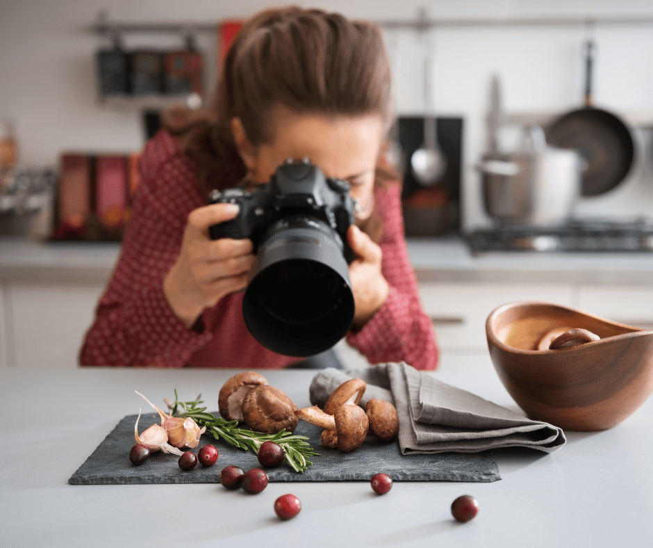 a food photographer in a kitchen taking a photo of food ingredients
