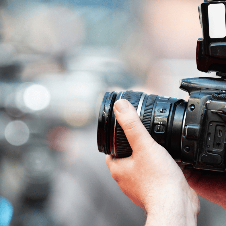 side profile view of a photographer holding their camera