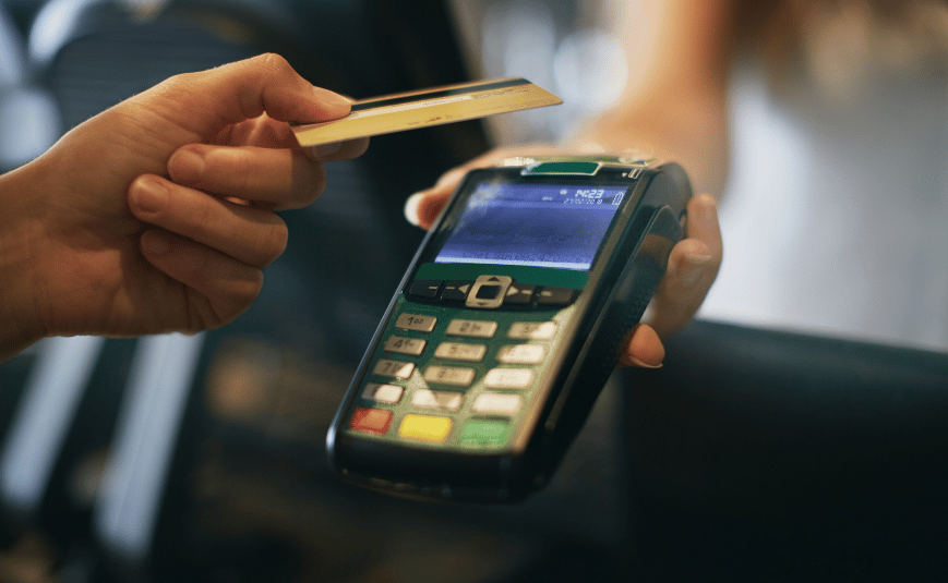 a person using a pinpad to use contactless card payment