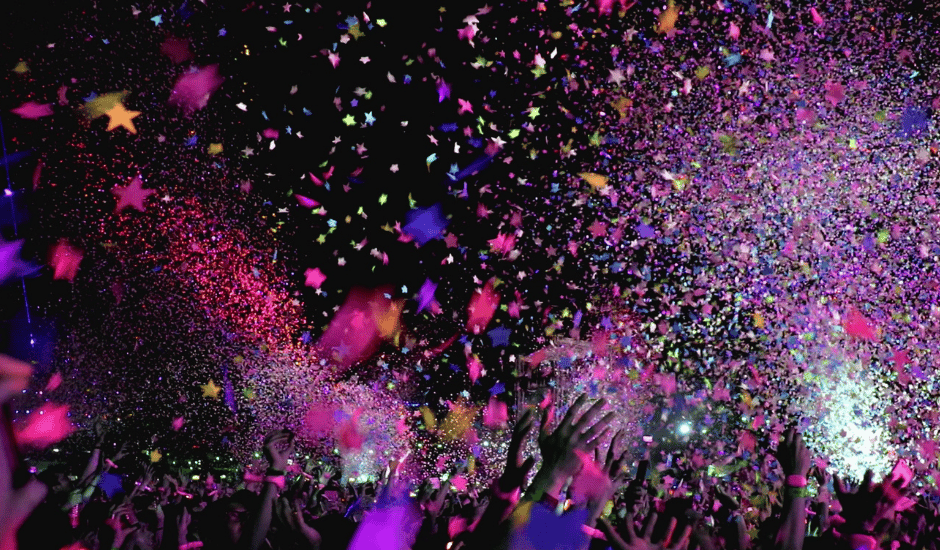 Outdoor concert event at nighttime with confetti