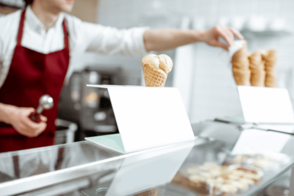 employee preparing ice cream for customer