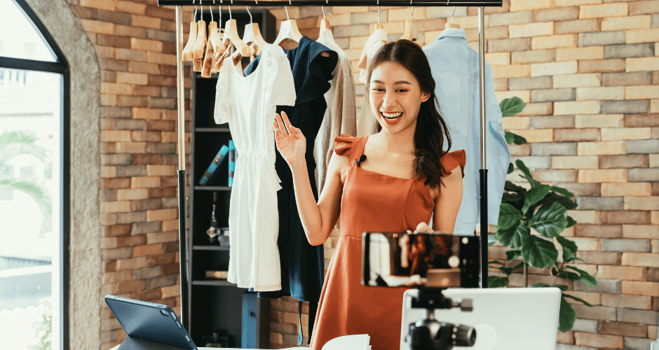 A girl running an online instagram thrift store taking product shots