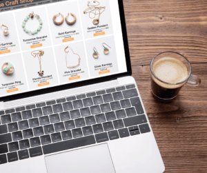 an online jewelry store on a laptop with a cup of coffee beside the laptop