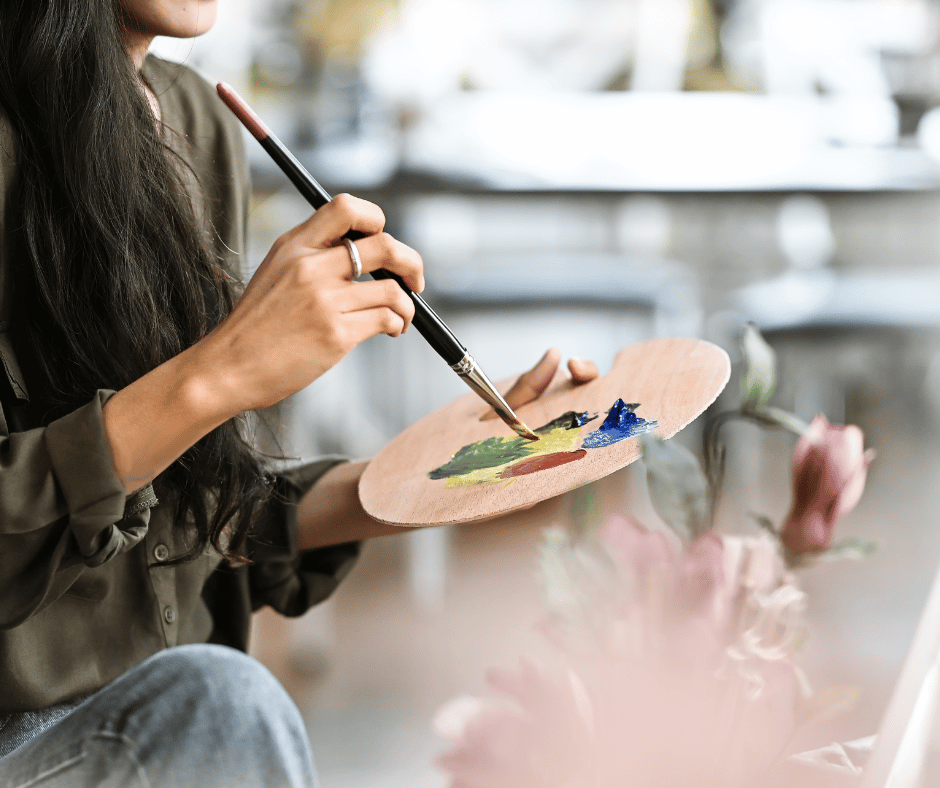 a female artist holding her paint palette 