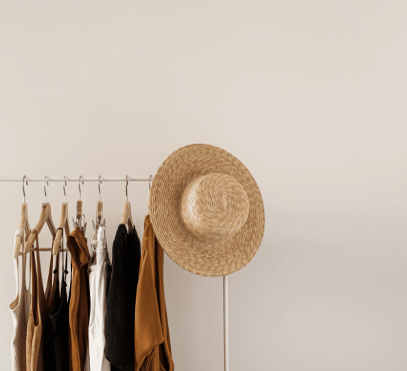 a minimalistic photo of neutral toned clothes on a rack