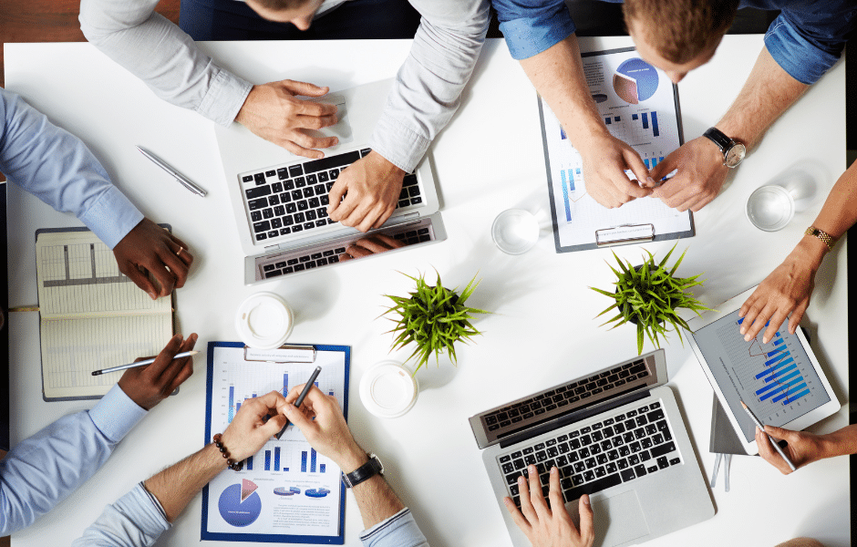 a team of employees collaborating around a desk