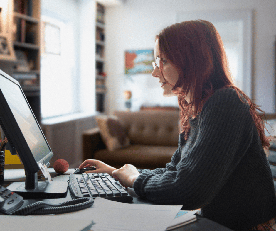 a woman working on a computer at a desk