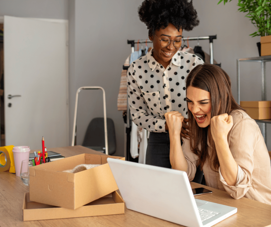 A small business team of women in excitement over a business victory. 